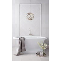 Thumbnail image of White marble tile on walls and floor of a bathroom with a soaker tub and decorations. 